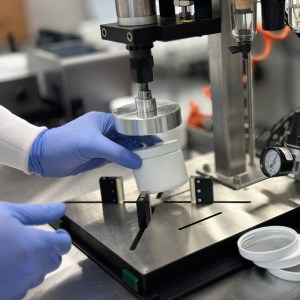 Production Technician Working on a Jar of Cosmetics